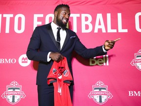 Toronto FC striker Jozy Altidore poses for photographers after speaking to the media after receiving a new long-term contract in February. THE CANADIAN PRESS/Nathan Denette