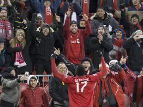 Toronto FC forward Jozy Altidore celebrates with fans after scoring his team's third goal against the New England Revolution during second half MLS soccer action in Toronto on Sunday, March 17, 2019. THE CANADIAN PRESS/Chris Young