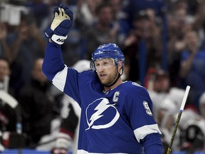 Tampa Bay Lightning centre Steven Stamkos (91) waves to the crowd after becoming the all-time franchise goal leader (384) against the Arizona Coyotes, Monday, March 18, 2019, in Tampa, Fla. (AP Photo/Jason Behnken)