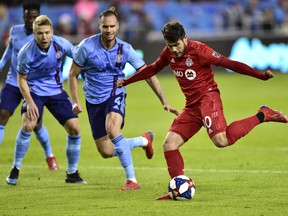 Toronto FC's Alejandro Pozuelo kicks towards the goal against New York City during first-half MLS action in Toronto on Friday, March 29, 2019. (FRANK GUNN/THE CANADIAN PRESS)