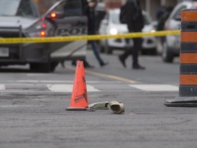 A croc and ballcap on the roadway after a female pedestrian was struck and killed at the intersection of Sherbourne and Bloor Sts. in Toronto early Friday March 29, 2019. Stan Behal/Toronto Sun
