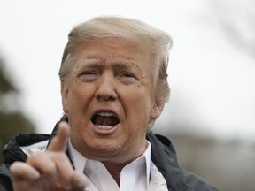 U.S. President Donald Trump talks with reporters outside the White House before traveling to Alabama to visit areas affected by the deadly tornadoes, Friday, March 8, 2019, in Washington.