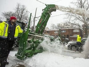 City crews begin the snow clearing operation starting with the snowbanks along a street near Yonge St. and Davisville Ave. on Saturday March 2, 2019. The machine on the left is giant version of a snowblower used at homes, the snow is being dumped into a truck. Ernest Doroszuk/Toronto Sun/Postmedia