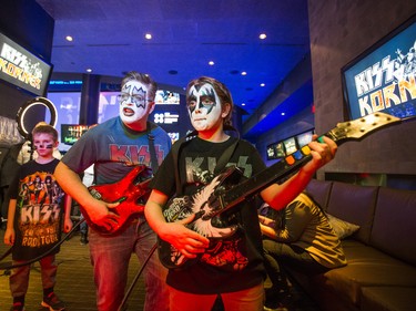 Tim Jones and his son, Andrew, 11 - from Sackville, New Brunswick -  enjoy some Guitar Hero Battle ahead of the Kiss concert during a pre-show party at RealSports Bar & Grill in Toronto, Ont. on Wednesday March 20, 2019. Ernest Doroszuk/Toronto Sun/Postmedia