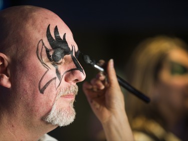 Ian Morris gets some Rock Star face painting done by make up artist Angela Lee ahead of the Kiss concert during a pre-show party at RealSports Bar & Grill in Toronto, Ont. on Wednesday March 20, 2019. Ernest Doroszuk/Toronto Sun/Postmedia
