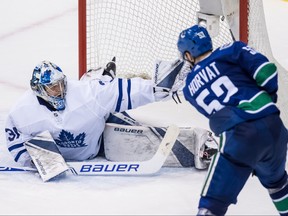 Toronto Maple Leafs goalie Frederik Andersen, left, makes a glove save to stop Vancouver Canucks' Bo Horvat during second period NHL hockey action in Vancouver on Wednesday, March 6, 2019. THE CANADIAN PRESS/Darryl Dyck