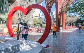 A couple poses for a photo in The Park in Las Vegas, Nevada