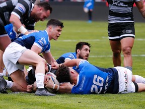 Toronto Wolfpack players, (black jerseys) battle against Toulouse Olympique players during the Betfred Championship Round 6 fixture in Toulouse, France on Saturday. (Stephen Gaunt, Toronto Wolfpack)