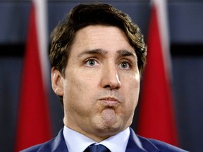 Prime Minister Justin Trudeau grimaces as he holds a news conference in Ottawa, Thursday March 7, 2019. THE CANADIAN PRESS/Fred Chartrand ORG XMIT: FXC102