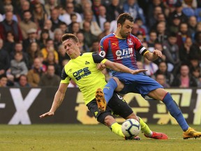 Huddersfield Town's Jonathan Hogg and Crystal Palace's Luka Milivojevic battle for the ball during their game on 
 Saturday. (AP PHOTO)