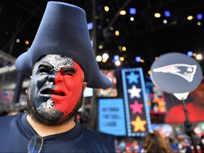 New England Patriots fan Derek Breton, of Huntsville, Ala., stands on the main stage ahead of the second round of the NFL football draft, Friday, April 26, 2019, in Nashville, Tenn. (AP Photo/Mike Stewart)