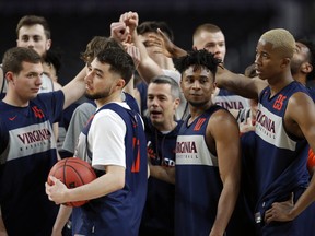 Virginia players huddle during a practice session for the semifinals of the Final Four on Friday. (AP PHOTO)