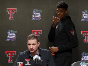 Texas Tech's Jarrett Culver (right) walks in as head coach Chris Beard answers questions during a news conference on Sunday. (AP PHOTO)