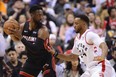 Miami Heat guard Dwyane Wade looks for a pass as Toronto Raptors' Norman Powell defends during Sunday's game. (THE CANADIAN PRESS)