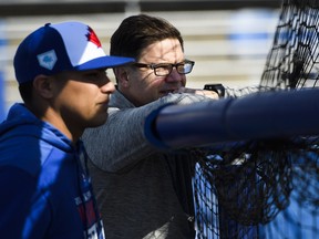 Blue Jays general manager Ross Atkins watches batting practice during spring training. (THE CANADIAN PRESS)