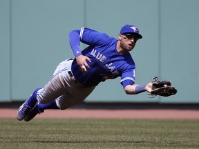 Toronto Blue Jays center fielder Kevin Pillar makes a diving catch on a fly ball by Boston Red Sox's Jackie Bradley Jr. during the eighth inning of a baseball game at Fenway Park, Monday, April 18, 2016, in Boston. (AP Photo/Mary Schwalm)