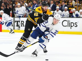 David Backes #42 of the Boston Bruins checks Travis Dermott #23 of the Toronto Maple Leafs in Game 2 in Boston last night. (Adam Glanzman/Getty Images)