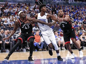 Jonathan Isaac of the  Magic getrs double-teamed down low by Raptors' Pascal Siakam (left) and Kawhi Leonard during Game 4 at the Amway Center on April 21, 2019 in Orlando, Florida. The Raptors defeated the Magic 107-85. (Photo by Don Juan Moore/Getty Images)