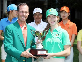 Nicole Gal, of Oakville, the Girls 14-15 winner, poses with her trophy and  Mike Weir during the Drive, Chip and Putt Championship at Augusta National Golf Club in Augusta, Ga., on Sunday.  Getty Images