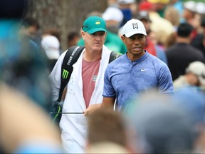 Tiger Woods and caddie Joe LaCava look on during a practice round prior to The Masters at Augusta National Golf Club on April 8, 2019 in Augusta, Georgia. (Andrew Redington/Getty Images)
