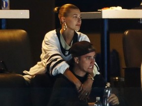Justin Bieber reacts and wife Hailey Bieber looks on during Game Seven of the Eastern Conference First Round during the 2019 NHL Stanley Cup Playoffs between the Boston Bruins and the Toronto Maple Leafs at TD Garden on April 23, 2019 in Boston, Massachusetts. (Photo by Omar Rawlings/Getty Images)