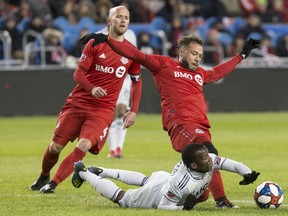 Toronto FC midfielder Nick DeLeon (right) has signed a contract extension with the team. (THE CANADIAN PRESS)