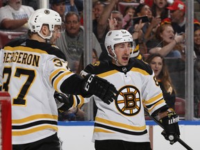 Boston Bruins' Brad Marchand celebrates a a goal with Patrice Bergeron. (GETTY IMAGES)