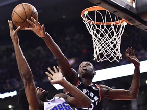 Orlando Magic forward Amile Jefferson and Toronto Raptors forward Chris Boucher  battle for the ball during a game earlier this season. (THE CANADIAN PRESS)