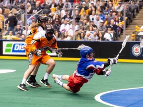 A member of the Toronto Rock is taken down while shooting against the New England Black Wolves on Friday. (RYAN MCCULLOUGH PHOTOGRAPHY)