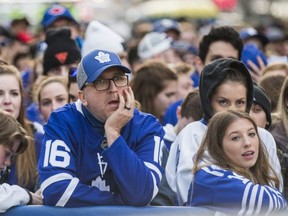 Fans view the Maple Leafs loss to the Boston Bruins on the big screens outside of Scotiabank Arena. (Ernest Doroszuk, Toronto Sun)