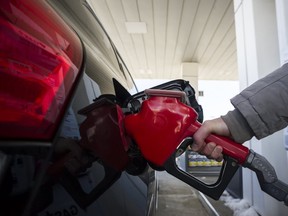 A woman fills up her with gas in Toronto, on Monday April 1, 2019. (THE CANADIAN PRESS)