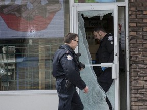 Police investigate a shooting on Jane St. at George's Convenience Store. (Craig Robertson, Toronto Sun)