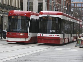 Streetcars pass each other on King St. on April 9, 2019. (Veronica Henri,