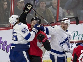 Ottawa Senators #15 Zack Smith gets tangled up with Tampa Bay Lightning #55 Braydon Coburn and #91 Steven Stamkos during first period NHL hockey action at Canadian Tire Centre in Ottawa on on April 1, 2019. Errol McGihon/Postmedia