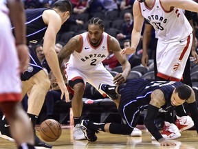 Toronto Raptors forward Kawhi Leonard battles for a loose ball against Orlando Magic guard D.J. Augustin last week. (THE CANADIAN PRESS)