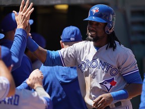 Blue Jays' Alen Hanson celebrates in the dugout during the team's sweep of the A's in Oakland. (GETTY IMAGES)