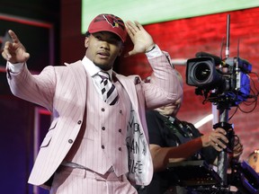 Oklahoma quarterback Kyler Murray waves after the Arizona Cardinals selected him first overall in Thursday's NFL draft. (AP PHOTO)