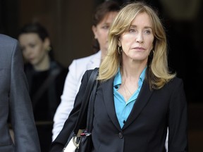 In this file photo taken on April 3, 2019, actress Felicity Huffman exits the courthouse after facing charges for allegedly conspiring to commit mail fraud and other charges in the college admissions scandal at the John Joseph Moakley United States Courthouse in Boston. (JOSEPH PREZIOSO/AFP/Getty Images)