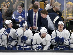 Maple Leafs head coach Mike Babcock (right) talks to his team on the bench during Game 2 on Saturday night in Boston. (Mary Schwalm/The Associated Pres)