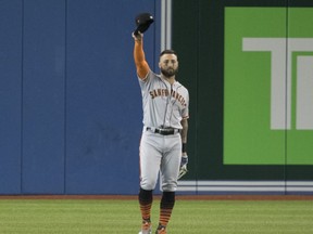 San Francisco Giants Kevin Pillar formerly with the Blue Jays acknowledges fans as he walks out to his centre field position in the first inning of their Interleague MLB baseball game in Toronto Tuesday April 23, 2019. THE CANADIAN PRESS/Fred Thornhill
