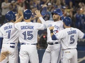 Toronto Blue Jays' Rowdy Tellez greeted by teammates at home plate after hitting a grand slam against the San Francisco Giants during the eighth inning of their Interleague MLB baseball game in Toronto Tuesday April 23, 2019. THE CANADIAN PRESS/Fred Thornhill