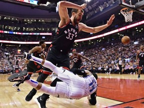 Toronto Raptors centre Marc Gasol collides with Orlando Magic guard D.J. Augustin during second half NBA basketball action in Toronto on Monday, April 1, 2019.
