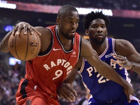 Toronto Raptors forward Serge Ibaka (9) controls the ball as Philadelphia 76ers center Joel Embiid (21) defends during first half NBA basketball action in Toronto on Wednesday, Dec. 5, 2018. THE CANADIAN PRESS/Frank Gunn ORG XMIT: FNG402