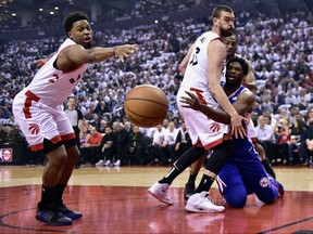 Philadelphia 76ers centre Joel Embiid (21) tries to pass the ball as Toronto Raptors centre Marc Gasol (33) and guard Kyle Lowry (7) defend first half, second round NBA basketball playoff action in Toronto, on Monday, April 29, 2019. THE CANADIAN PRESS/Frank Gunn