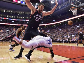 Toronto Raptors centre Marc Gasol (33) collides with Orlando Magic guard D.J. Augustin (14) during second half NBA basketball action in Toronto on Monday, April 1, 2019. THE CANADIAN PRESS