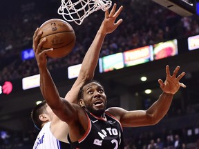 Toronto Raptors forward Kawhi Leonard (2) is fouled by Orlando Magic centre Nikola Vucevic (9) during first half NBA basketball action in Toronto on Monday, April 1, 2019. The Toronto Raptors are about to tip off perhaps the most-anticipated post-season run in franchise history. The Raptors rebuilt with a long playoff run in mind, but can't look past the Orlando Magic, who handed Toronto two of their ugliest losses of the regular season.THE CANADIAN PRESS/Frank Gunn ORG XMIT: CPT114