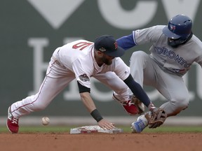 Toronto Blue Jays' Teoscar Hernandez, right, steals second base as the ball gets away from Boston Red Sox second baseman Dustin Pedroia during the seventh inning in Boston on Tuesday. (AP Photo/Charles Krupa)