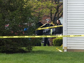 A body is loaded into a Butler County coroner's van Monday, April 29, 2019 after multiple people were found dead at the Lakefront at West Chester apartment complex in West Chester Township, Ohio on Sunday night, according to police.