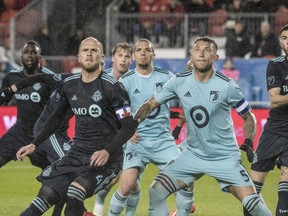 Toronto FC’s Michael Bradley (left) and Minnesota United’s Francisco Calvo look for a header front of Minnesota ‘s net during first-half MLS action in Toronto last Friday. The Reds lost top scorer Jozy Altidore to injury in the game. (THE CANADIAN PRESS)