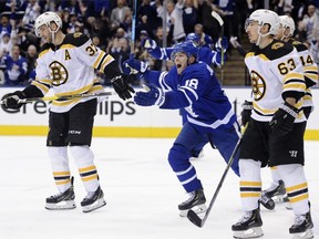 Bruins top-liners Patrice Bergeron (left) and Brad Marchand (right) look on while Leafs’ Andreas Johnsson celebrates his goal in Game 3.  THE CANADIAN PRESS